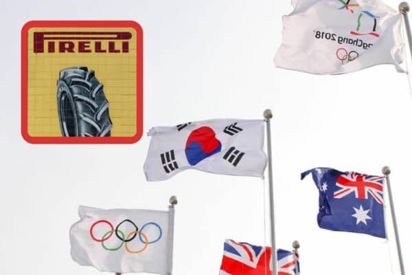 Logo Pirelli na tle flag olimpijskich i flagi korei poludniowej.