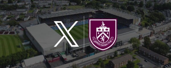 Logo klubu Premier League Burnley i platformy X na tle stadionu The Clarets