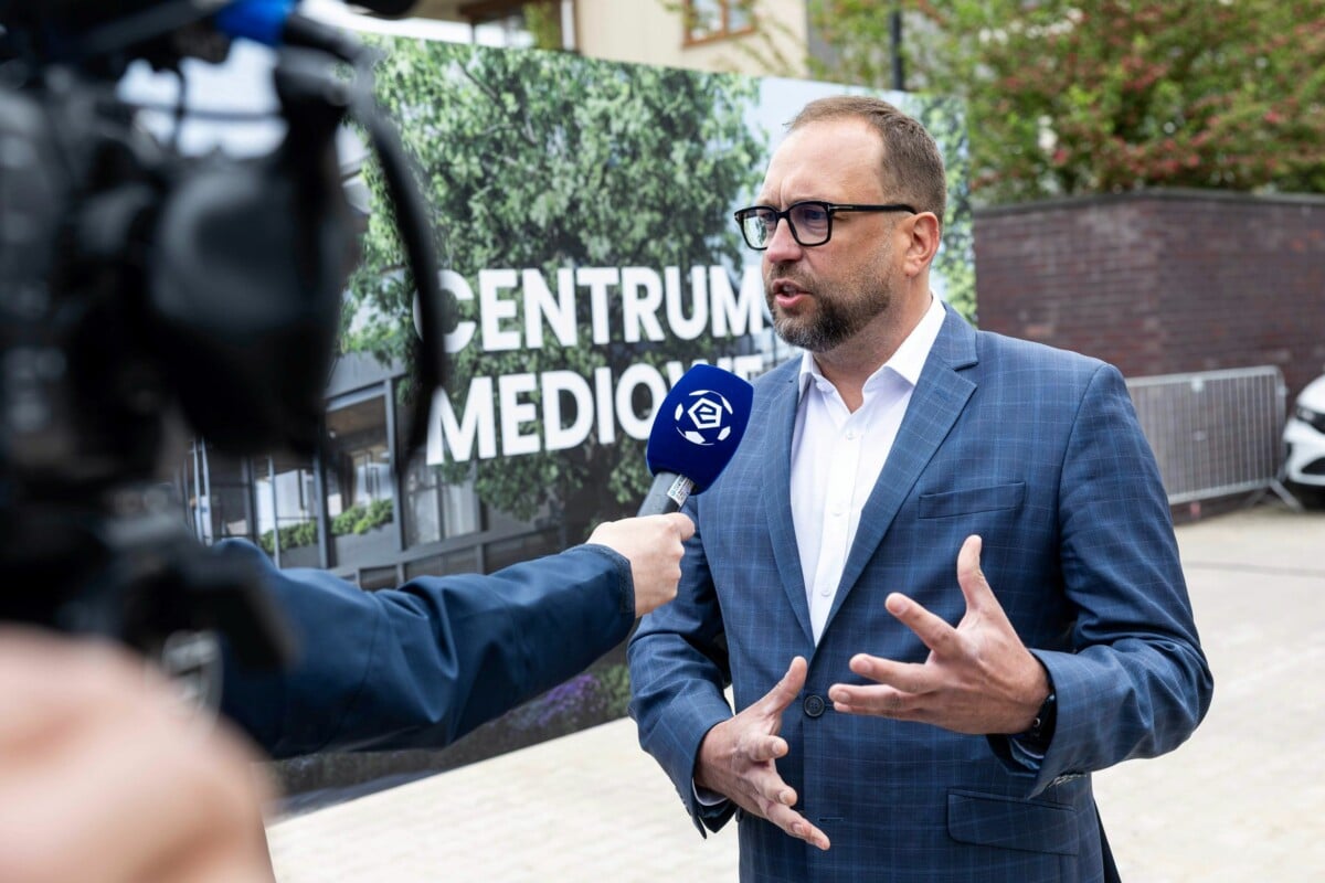 Marcin Animucki, prezes Ekstraklasy SA, udziela wywiadu na tle napisu Centrum Mediowe podczas uroczystości wmurowania kamienia węgielnego.