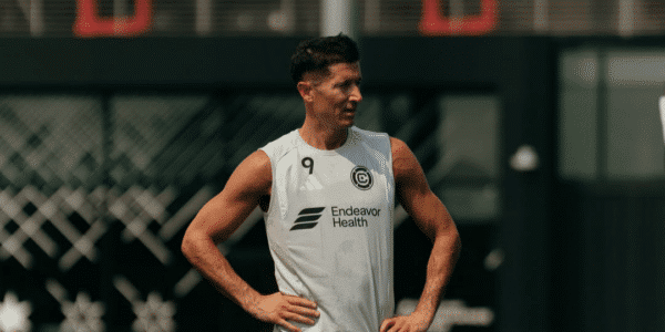 Robert Lewandowski w stroju treningowym Chicago Fire z numerem 9 stoi na boisku treningowym Endeavor Health Performance Center.