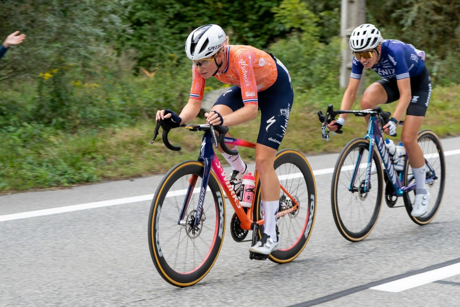 Demi Vollering w pomarańczowym stroju jadąca na rowerze szosowym podczas Tour de France Femmes